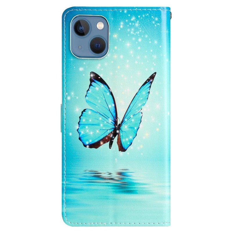 Etui Folio do iPhone 15 z Łańcuch Niebieski Motyl W Locie Z Paskiem