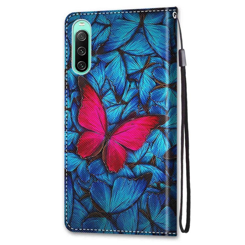 Etui Folio do Sony Xperia 10 IV Czerwony Motyl Niebieskim Tle